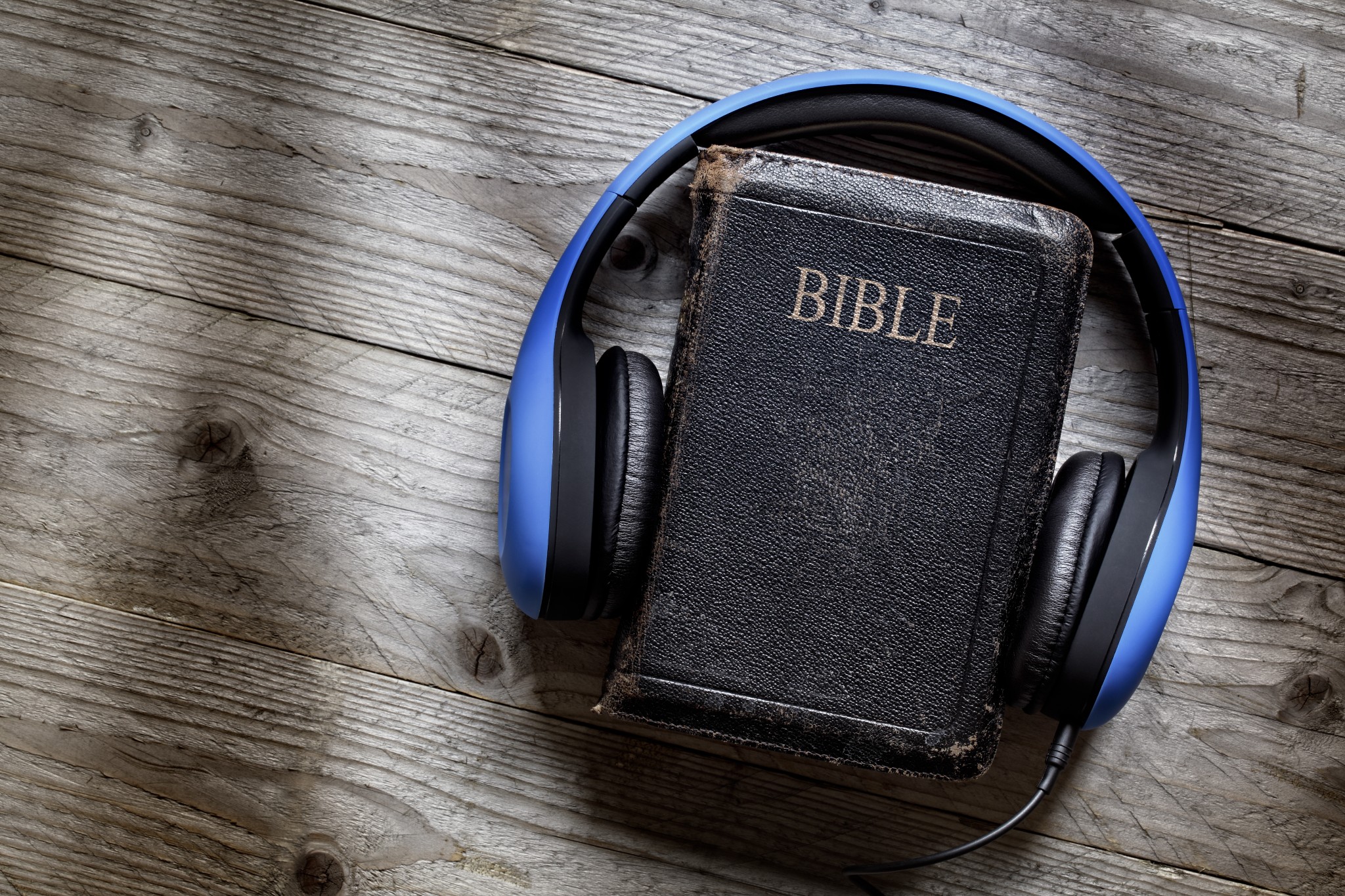 bigstock-Holy-Bible-and-headphones-conc-85349378